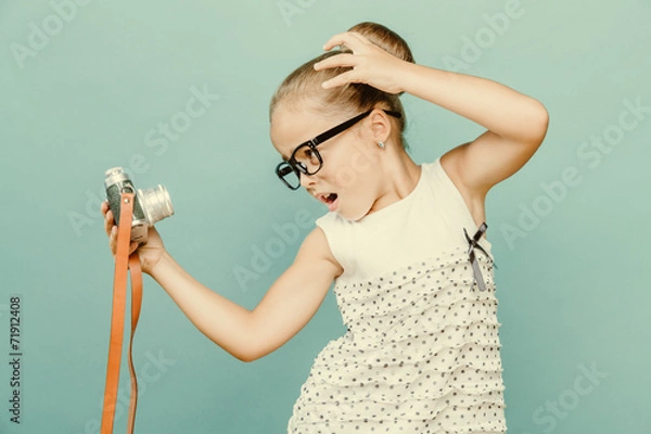 Obraz child holding a instant camera