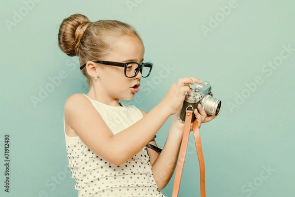 Obraz child holding a instant camera