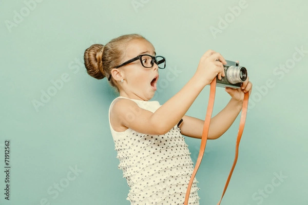 Obraz child holding a instant camera