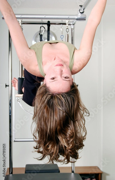 Obraz Pilates Instructor Hanging from Trapeze Table 