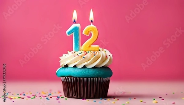 Obraz Birthday cupcake with burning lit candle with number 12. Number twelve for twelve years or twelfth anniversary.