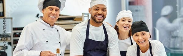 Fototapeta jolly diverse chefs and chief cook smiling at camera while working with dough, confectionery, banner