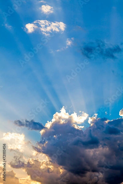 Obraz Clouds In The Blue Sky and Sun Rays