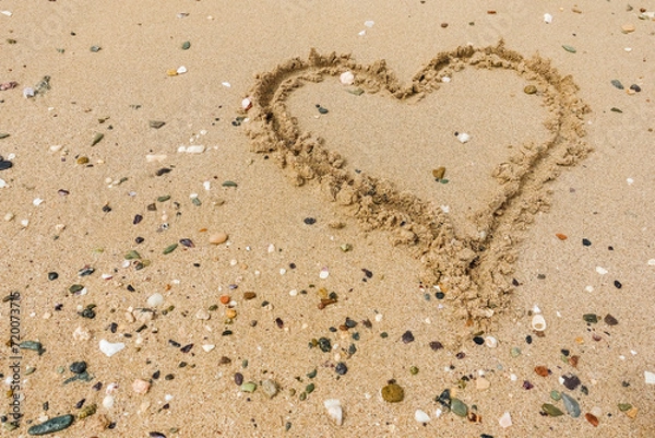 Obraz drawn heart in the sand from a beach with lot of corals and stones