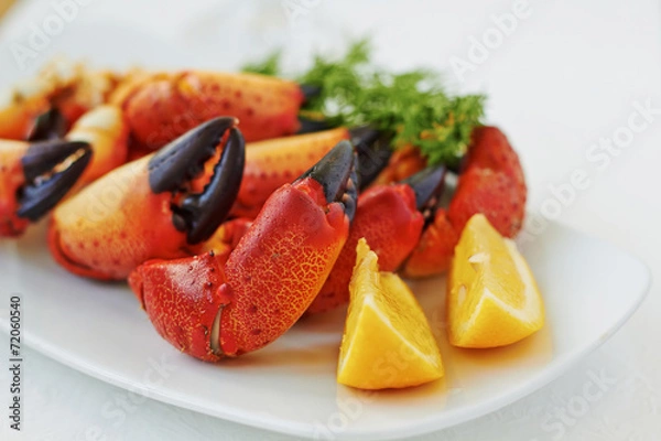 Fototapeta Boiled crab claws with lemon and dill