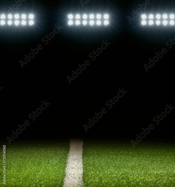 Obraz Grass athletic field with white stripe and dark background below stadium lights