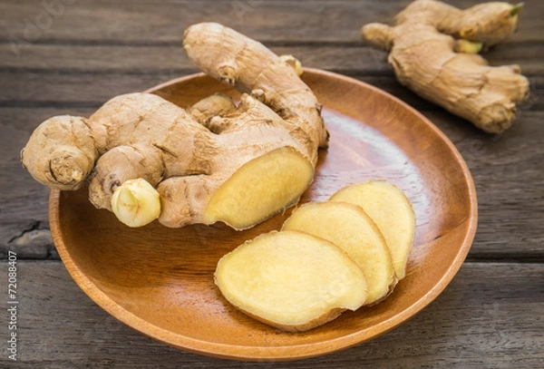 Obraz Ginger root sliced on wooden plate