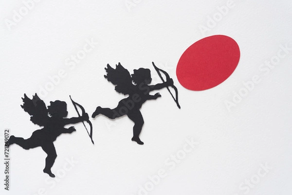 Fototapeta two Valentine's Day cupid silhouettes and red oval dot on blank paper