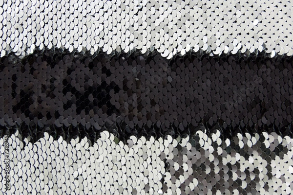 Fototapeta fabric is covered with silver and black sequins