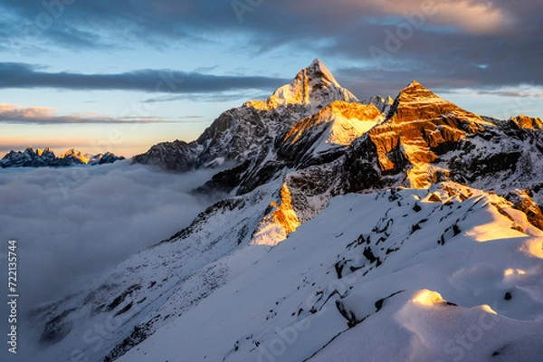 Fototapeta Mount Siguniang, Four Girls Mountain the Sacred Mountain in the East, National Geo-park of China, Sunset over a sea of clouds in the mountains with golden light touching snowy peaks
