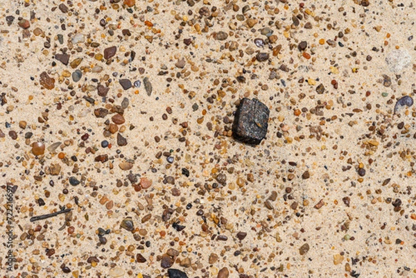 Fototapeta Background with metallic content stones on beach sand