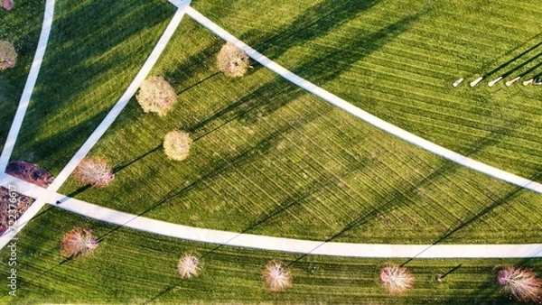 Fototapeta Sidewalks cutting through the grass