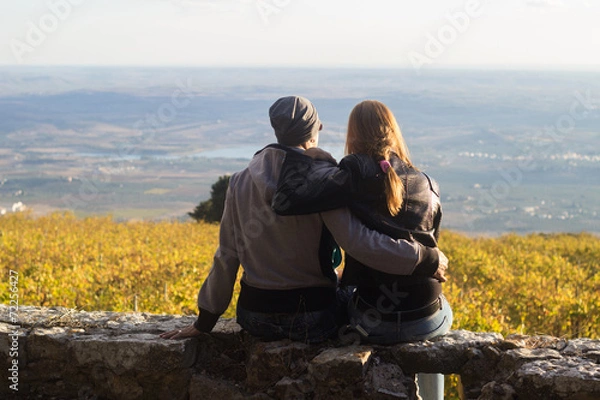 Fototapeta Hugging couple enjoying sunset
