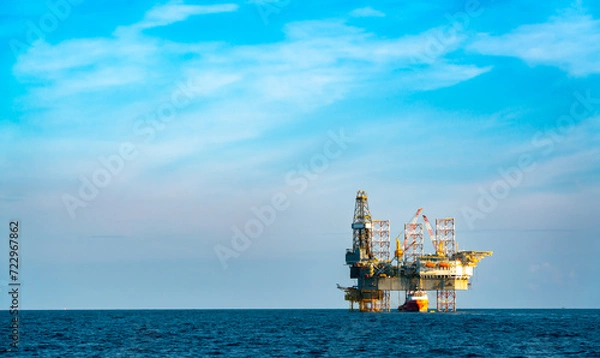 Fototapeta Remote offshore oil and gas exploration and drilling vessels that produce raw materials for delivery to onshore refineries, power generation and the petrochemical industry.
