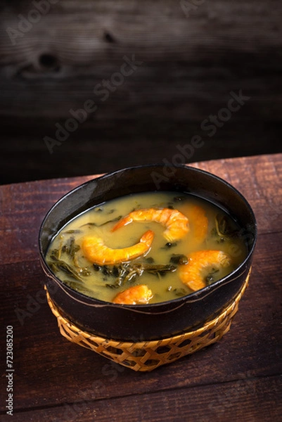 Fototapeta Tacacá, typical food from the Brazilian Amazon. Made with tucupi, jambu and shrimp.
