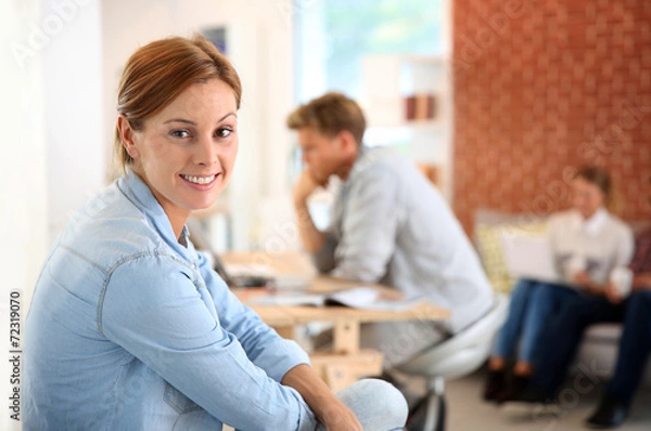 Fototapeta Smiling woman sitting in shared apartment