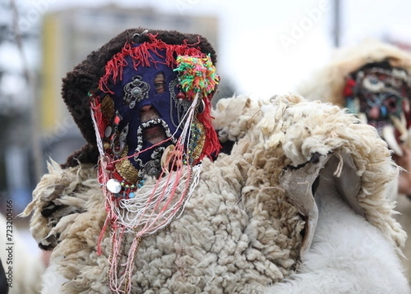 Fototapeta Pernik, Bulgaria - January 27, 2024: The 30th International masquerade festival Surva in Pernik, Bulgaria. People with mask called Kukeri dance and perform to scare the evil spirits.