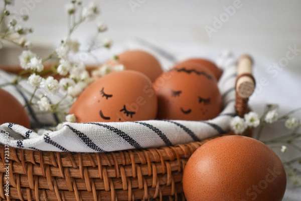 Obraz Easter eggs on a rustic table in a basket.