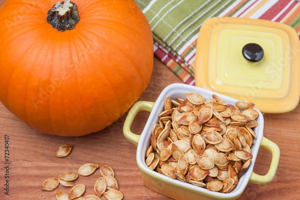 Obraz Roasted pumpkin seeds and pumpkin - top view