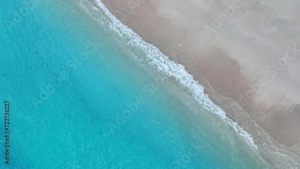 Fototapeta The soft wave water of the sea on the sandy beach background