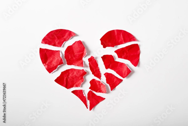 Fototapeta Pieces of crumpled and torn red heart shape paper isolated on white background paper. Broken heart concept.