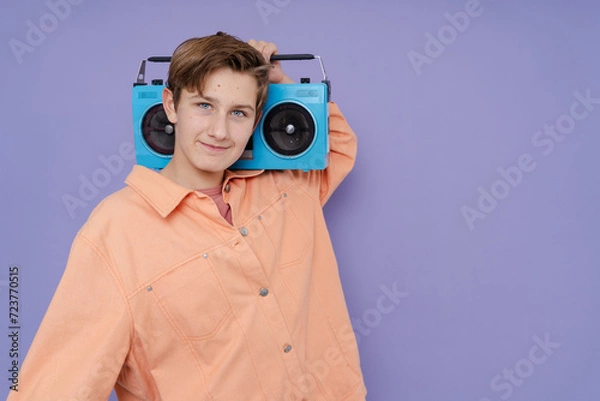 Fototapeta Photo of young man hold boom box  isolated on color background