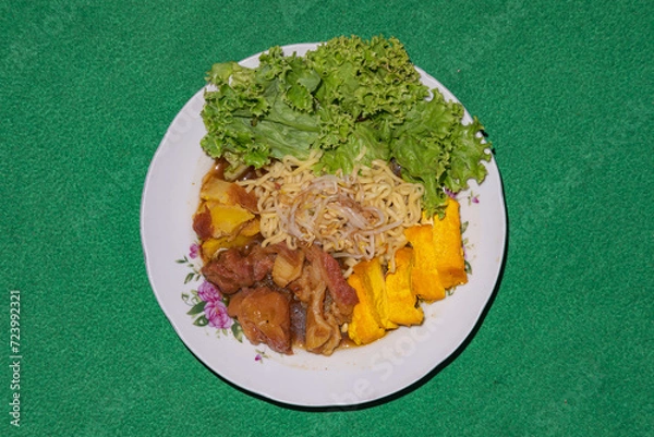 Fototapeta Tahu campur Lamongan (Mixed tofu), is a signature dish from Lamongan, East Java, Indonesia. It has rice cake, noodle, tofu, beef, bean sprout in beef curry.