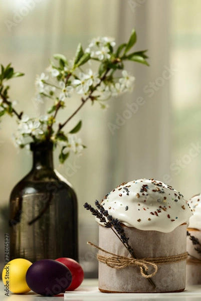 Fototapeta Traditional Orthodox Easter cakes and colored eggs, on a white table in the middle plan on a light background. happy Easter