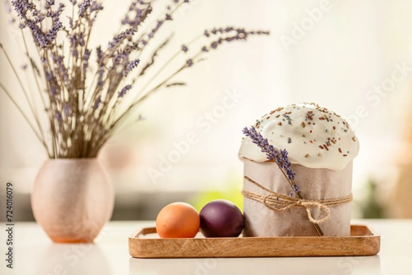 Fototapeta Traditional Orthodox Easter cake and colored eggs, on a white table in the middle plan on a light background. happy Easter
