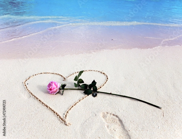 Obraz On a beach heart is drawn and the rose lies