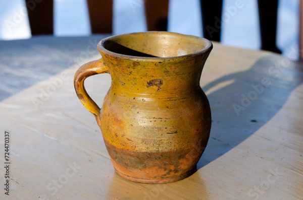 Fototapeta Ceramic dishes on the table. Antique vase. Archaeological finds. Pottery production. Vintage jug for liquid.