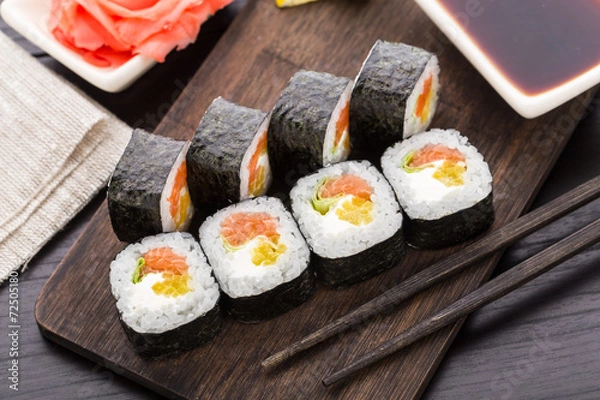 Fototapeta Sushi rolls with salmon and vegetables