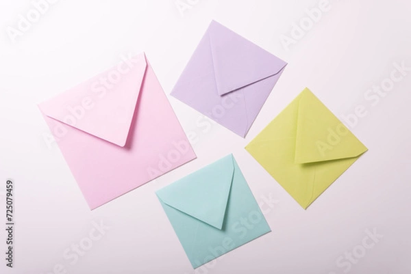 Obraz Valentines day envelope birthday party invitations yellow pink green purple top view white background different size pin