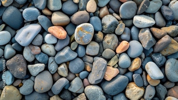 Fototapeta Close-up of pebble stones on the shore, creating a natural beach stones background in a top view, Ai Generated