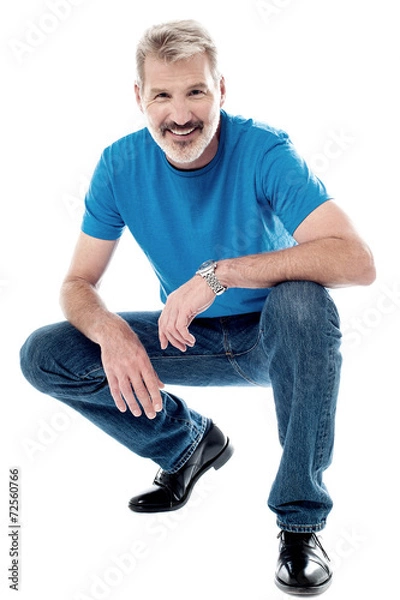 Obraz Handsome man crouching down and smiling