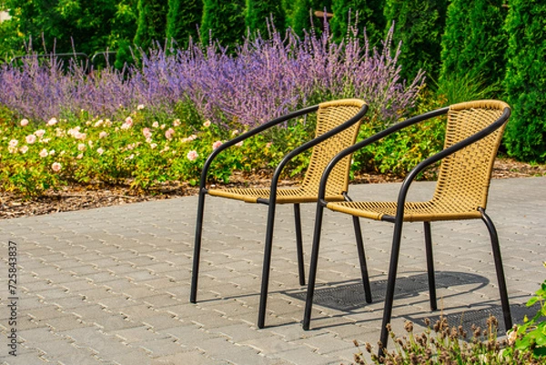Fototapeta two empty waiting chairs against the background of heather