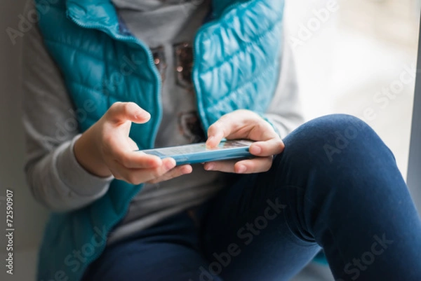 Fototapeta Close up of a Human hand using smartphone