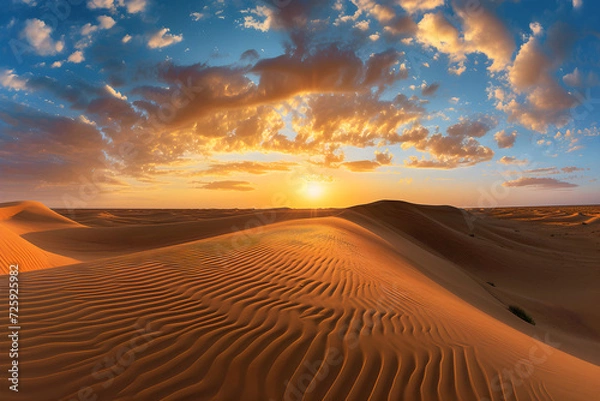 Fototapeta Sunset over the arid landscape of the desert, showcasing golden sand dunes under an orange sky during a hot summer evening