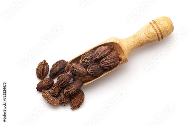 Fototapeta Top view of Organic Black cardamom (Amomum subulatum), in a wooden scoop. Isolated on a white background.
