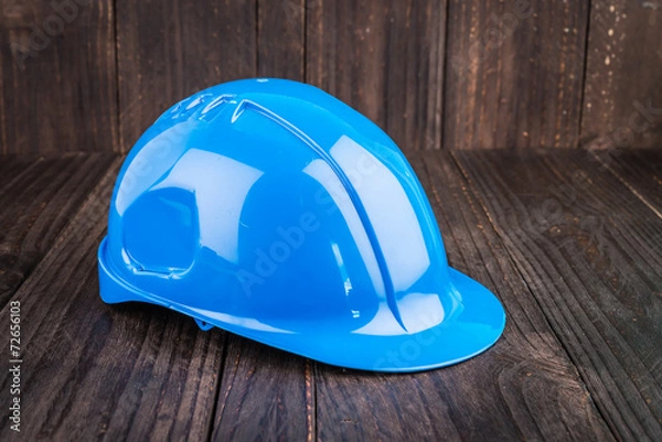 Obraz Construction hard hat on wooden background