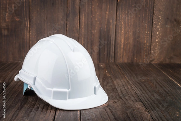 Obraz Construction hard hat on wooden background