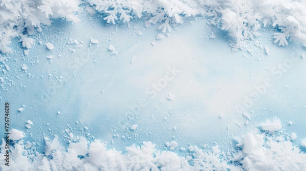 Fototapeta Frosty snowflakes and ice crystals on a blue background.