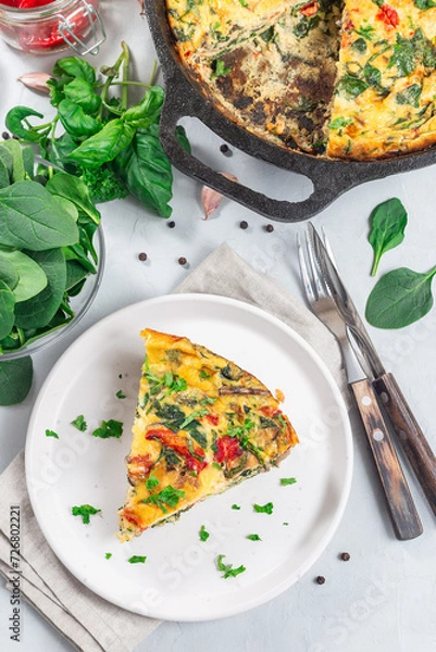 Obraz Piece of brunch egg frittata with vegetables on plate, vertical, top view
