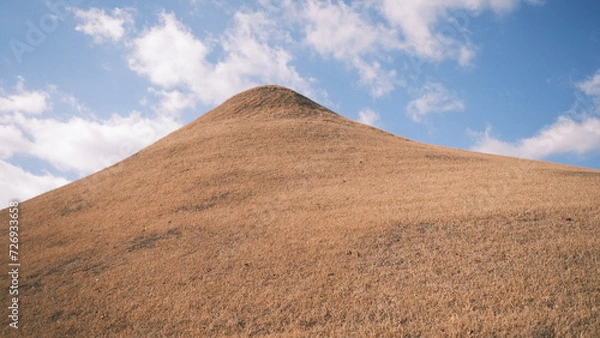 Fototapeta epic hill with blue sky and clouds in the background 