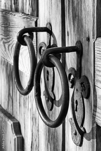 Obraz Old wooden door with two keyholes and two ring-shaped handles