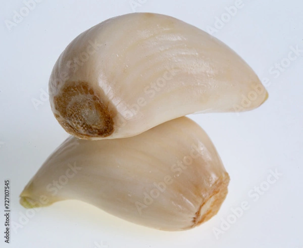 Fototapeta Two garlic cloves on white 