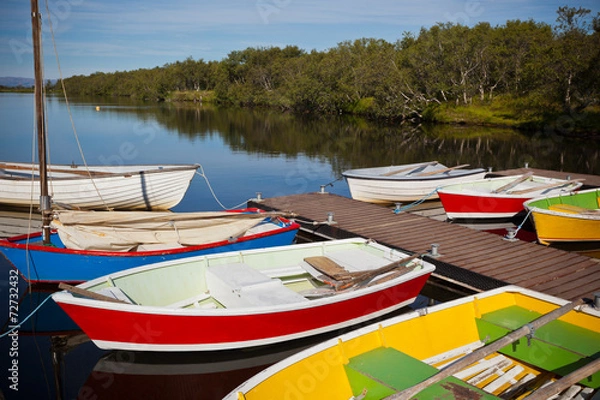 Fototapeta Color Wooden Boats with Paddles in a Lake