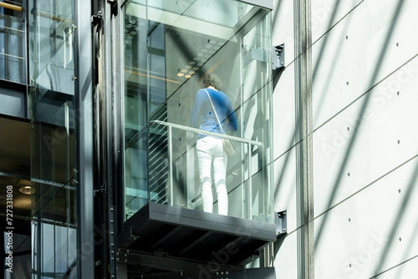 Obraz Woman on transparent elevator