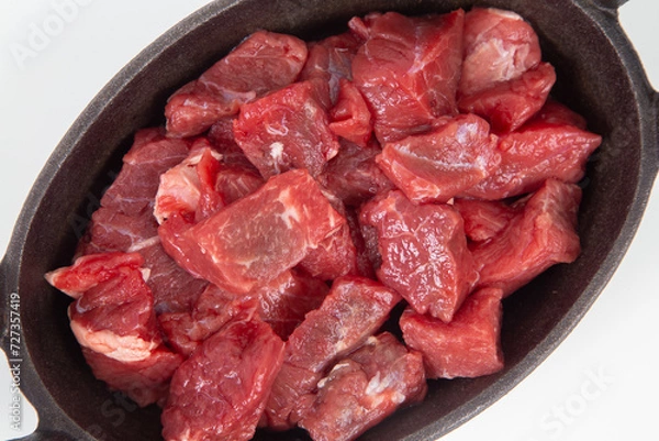 Fototapeta Cutting beef in iron plate
