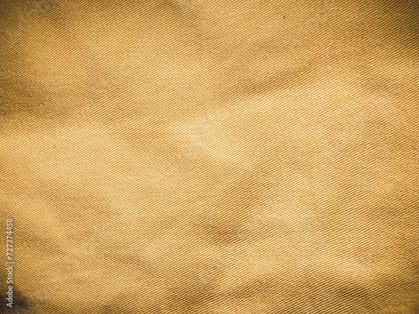 Fototapeta old khadi fabric texture background. light natural linen texture for the background.Golden yellow linen fabric of table cloth texture background.